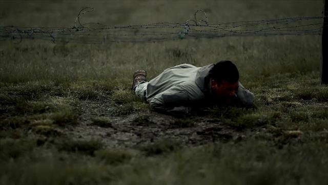 Soldiers Crawling Under The Barbed Wire Fence On Muddy Soil - The Stock ...