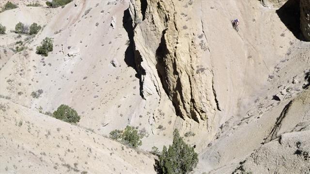 Aerial View Of Man Cycling Down The Hill