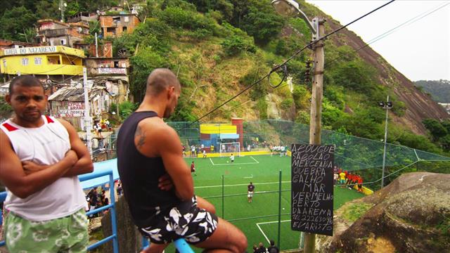 High Angle Record Of People Playing Soccer And Watching Game