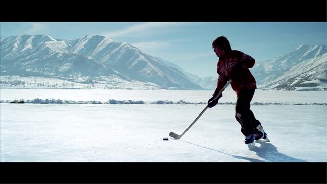 People Playing Ice Hockey In The Rink Pushing The Puck