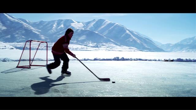 People Playing Ice Hockey Pushing The Puck