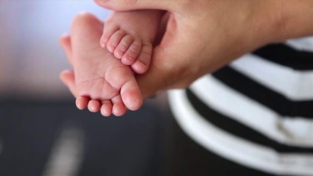 Close Up Shot Of People Holding Baby’s Feet